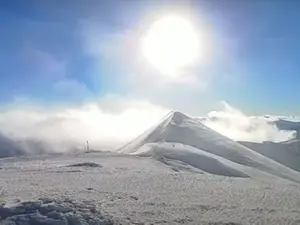 VIDEO Imagini de colecţie cu soarele şi zăpada viscolită, de pe vârful Omu, din Masivul Bucegi - captură YouTube